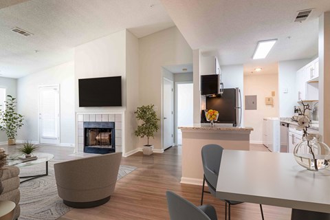 a living room with a fireplace and a table and chairs